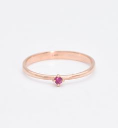 Genuine Ruby Ring set with Ruby, size 2 millimetres diameter, 0.03 Carats.Solid 14k Rose Gold ☞ made to last. Click here for ☞ Solid Gold CollectionRuby Details:• Genuine Ruby • Weight: 0.3 Carats • Dimensions: 2mm• Color: Red• Cut: Diamond Cut• Origin: Burma Setting Details:• 1.20 grams of 14k Solid Rose Gold • Dimensions: Band width ≈ 2.2mm, thickness ≈ 0.7mm• Lasts a lifetime - Perfect for everyday use (won't tarnish) *Final weight & dimensions depending on the chosen ring size SKU YR-1273-1 Rose Gold Solitaire Birthstone Ring In 14k Gold, 14k Rose Gold Birthstone Ring For Promise, Dainty Rose Gold Ruby Promise Ring, Stackable Ruby Ring In 14k Rose Gold, 14k Rose Gold Ruby Promise Ring, 14k Rose Gold Stackable Birthstone Rings, Rose Gold 14k Birthstone Ring With Round Band, Rose Gold Ruby Birthstone Ring For Promise, Formal Rose Gold Ruby Ring With Round Band