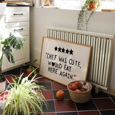 a sign that says chef was cute would eat here again next to some fruit on the floor