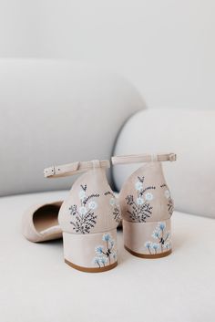 a pair of shoes sitting on top of a white couch