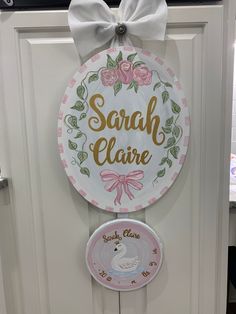 the door is decorated with pink and white plates that say, sarah clarie