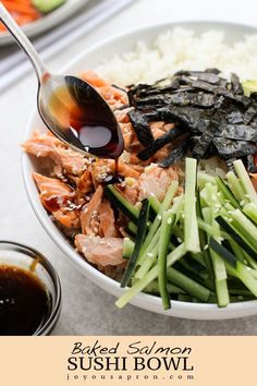 a bowl filled with meat and vegetables on top of rice next to dipping sauces