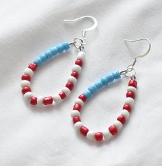 These handmade patriotic American flag beaded earrings are the perfect addition to any outfit. They are lightweight, comfortable, and made of hypoallergenic materials.  2.5 inches in length. You have the option of gold- or silver-colored ear hooks. Care Instructions: - Keep away from moisture - Remove when sleeping - Remove before entering water - Store in cool dry area - Gently wipe with soft cloth to clean These unique handmade earrings would make the perfect birthday gift, anniversary gift, b Red Jewelry With Ear Wire For Independence Day, Handmade Red Jewelry For Independence Day, Red Handmade Jewelry For Independence Day, Patriotic Beaded Earrings For 4th Of July, Beaded Earrings For 4th Of July Gift, Handmade White Earrings For 4th Of July, Handmade Red Beaded Earrings For 4th Of July, Patriotic Colorful Beaded Jewelry Gift, Red Beaded Earrings For 4th Of July