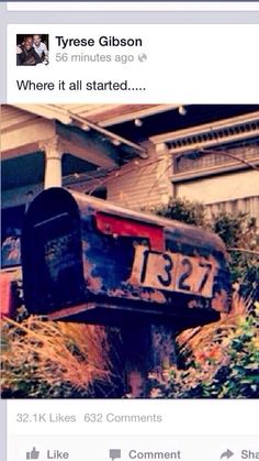 an old mailbox sitting in front of a house