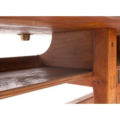 a close up of a wooden shelf with metal knobs