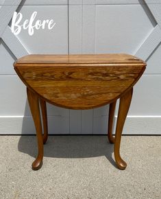 a small wooden table sitting in front of a garage door with the words before written on it