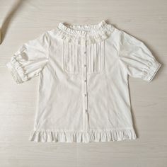 Features: It features ruffled stand collar, short sleeves, placket with five buttons, flounce hem.Attention: This price includes a shirt only, others are not included.&nbsp;Size Chart:Size (CM): Unit CM; Sizes below are measured in flat-laid position, hand measurement will have discrepancy of about 2 CM.Size(cm)XSSMLXLXXLShoulders353637383940Bust8286909498102Short / Long Sleeve Length26/5626/5626/5826/5826/6026/60Shirt Length555557575959 Casual Short Sleeve Blouse With Ruffles, Casual Short Sleeve Ruffled Blouse, Feminine Short Sleeve Shirt With Buttons, Feminine Short Sleeve Shirt For Daywear, Classic Summer Tops With Ruffles, Classic Ruffled Summer Tops, Casual Short Sleeve Blouse With Ruffle Hem, Feminine Short Sleeve Blouse With Ruffles, Feminine Short Sleeve Tops With Ruffles