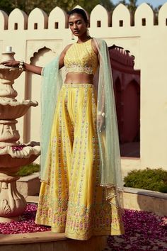 Yellow floral resham and mirror embroidered padded top with a scalloped edge. Paired with an embroidered palazzo and contrast dupatta. - Aza Fashions Sleeveless Lehenga With Floral Embroidery For Eid, Sleeveless Embroidered Palazzo Set For Festivals, Embroidered Sleeveless Palazzo Set For Festivals, Spring Wedding Palazzo Set With Mirror Work, Summer Silk Palazzo Set With Mirror Work, Sleeveless Floral Embroidered Choli For Eid, Sleeveless Floral Embroidery Choli For Eid, Spring Reception Set With Mirror Work, Sleeveless Chanderi Set With Intricate Embroidery