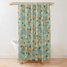 a shower curtain with an orange and green floral pattern