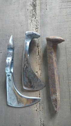 three tools are laying on the ground next to each other, including an old pair of hammers