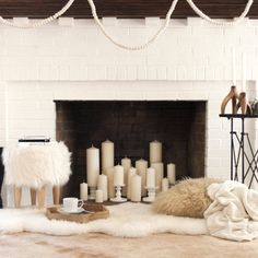 a living room filled with furniture and a fire place covered in fur rugs next to a fireplace