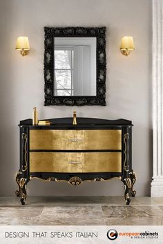 a bathroom vanity with gold and black accents in front of a large mirror on the wall