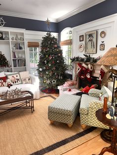 a living room filled with furniture and a christmas tree