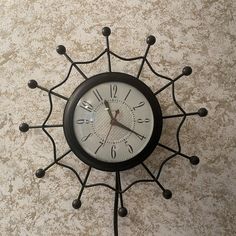 a black and white clock on the wall