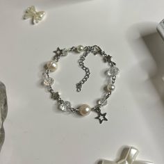 "Pearl Bracelet with Star charms! (adjustable length: with adjuster 5.5\" -> 7.5\") Made with Freshwater pearls, Stainless Steel hardware, and Glass beads Each product is handmade, so slight variations may occur! each is uniquely yours 🤞 🌷͜ (ᵔ ̮ ᵔ)› [ordering 2 or more items from my shop will get you a random freebie]  🍡each order comes with a sticker or candy 🍓CARE INSTRUCTIONS (non ss metals) Keep away from liquids! Creams/Perfumes/Creams, etc. Make sure to remove before showering and slee Bracelet Ideas Metal, Handmade White Beaded Metal Bracelets, Handmade White Beaded Metal Bracelet, Vintage Beaded Bracelets For Gift, Metal Beaded Rosary Bracelet Gift, Metal Beaded Rosary Bracelet For Gift, Vintage Silver Beaded Bracelets As Gift, Bracelet To Make, Small Business Jewelry