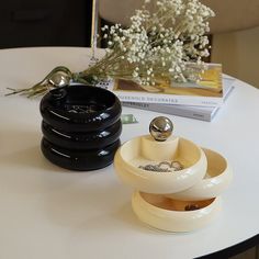 a white table topped with two black and white dishes