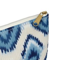 Inspired by the ancient art of Ikat, our blue-hued pouch is a timeless nod to cultural elegance. This trendy accessory brings the charm of Indonesia with its playful Ikat print, adding a touch of coastal chic to your daily adventures. Whether you're on the move or seeking stylish organization, this pouch effortlessly blends casual flair with the richness of ancient Ikat art. Carry the cool blues with you wherever you go!Our pouches vary from small to large and can be used for pretty much anythin Blue Rectangular Cosmetic Bag With Zipper Pocket, Blue Zipper Pouch For Daily Use, Blue Bohemian Rectangular Pouch, Blue Rectangular Pouch With Zipper Closure, Blue Travel Pouch With Zipper Pocket, Blue Bag With Zipper Pouch As Gift, Blue Zipper Pouch Cosmetic Bag For Everyday Use, Blue Pouch With Zipper Closure For Everyday Use, Blue Zipper Pouch Cosmetic Bag Gift