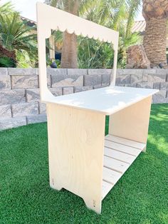 a wooden step stool sitting on top of green grass