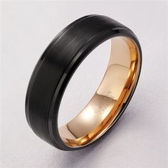 a black and gold wedding ring on a white background