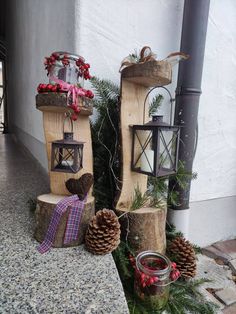 christmas decorations made out of logs and pine cones on the ground next to a lamp post