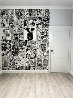 an empty room with wood floors and a wall covered in comic book pages on it