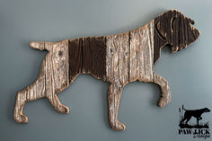 a dog made out of wood hanging on the wall