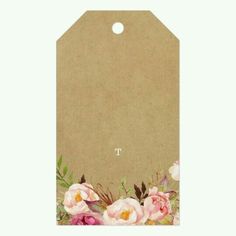 a brown paper tag with pink flowers on it