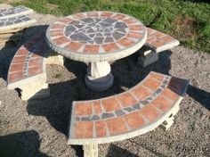 three stone benches sitting on top of gravel