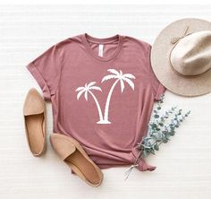 "Palm Tree Shirt, Palms Shirt, Summer Vacation T-Shirt, Palm Beach Shirt, Summer Tee, Botanical Shirt, Hawaii Shirt, Tropical Shirt ☀️☀️☀️☀️☀️ Everything in our shop is hand crafted and made to order. If you want different color or size contact me! If you would like something custom made to fit your personal style please message me and I will do everything to get you that something special. ---How To Order--- ⭐️Please, check and review all photos ⭐️Choose your t-shirt size and color ⭐️Enter your Summer Cotton T-shirt With Palm Tree Print, Cotton Crew Neck Top With Palm Tree Print, Cotton T-shirt With Palm Tree Print In Relaxed Fit, Casual Crew Neck Top With Palm Tree Print, Relaxed Fit Cotton T-shirt With Palm Tree Print, Relaxed Cotton Top With Palm Tree Print, Casual Cotton Tops With Palm Tree Print, Palm Tree Print Relaxed Fit Short Sleeve Tops, Casual Cotton Top With Palm Tree Print