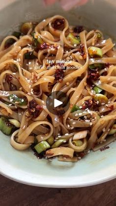 a white bowl filled with noodles and vegetables