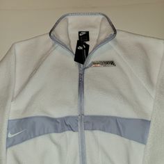 Nike Sportswear Women's Sherpa Jacket White Size Medium Or Small Cover Up In Wool-Like Warmth. The Nike Sportswear Sherpa Jacket Is Made With Plush Fleece For An Ultrasoft, Cozy Feel. A Supersized Swoosh Logo On The Back Brings The Energy To This Color-Blocked Design. Benefits Relaxed Sleeves Provide A Relaxed, Oversized Look. Soft Fleece Has A Cozy, Warm Feel. A Full-Length Zipper Lets You Adjust The Coverage. Product Details Oversized Fit For A Baggy, Spacious Feel 100% Polyester White Track Jacket For Winter Outdoor Activities, Nike Sporty Fleece Jacket For Sports, Sporty White Outerwear For Outdoor Activities, White Nike Track Jacket Functional, Sporty Fleece-lined Track Jacket For Winter Sports, White Fleece Sports Jacket For Winter, White Nike Track Jacket For Outdoor Activities, White Fleece Jacket For Sports In Winter, White Fleece Jacket For Winter Sports