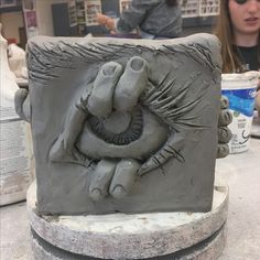 a clay sculpture of an elephant with its trunk in the shape of a human face