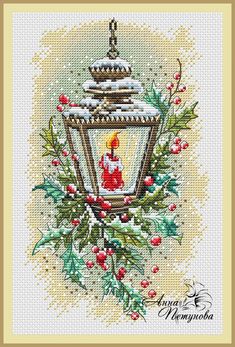 a cross stitch christmas card with a lit candle and holly wreath on the front, surrounded by red berries