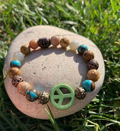 Green Peace Sign surrounded by Turquoise Siderolite, Jasper, Natural Agate, & Metallic Metal Beads.  Such an earthy 🌍 bracelet.  Made with super strong stretch elastic for easy on/off removal.  Can 🐝 worn alone or stacked.  Handmade with Love  💚☮️ Please note: Contains small parts, not recommended for children 0-3. Children over this age should be supervised if wearing. Turquoise Hippie Bracelets As Gift, Turquoise Hippie Bracelets For Gifts, Bohemian Hypoallergenic Bracelets, Bohemian Hypoallergenic Beaded Bracelets, Green Peace Sign, Peace Sign Bracelet, Bracelets Hippie, Green Peace, Buddha Bracelets