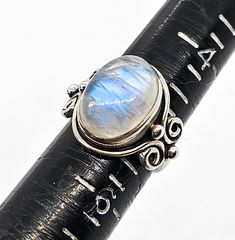 Arya Blue moonstone flashy Bali sterling silver ring. Good used condition with little signs of normal wear. Stamped on the inside of the band Arya 925. Beautiful blue flash along this oval gemstone cabochon. Ring measures size 5. Sterling Silver Oval Cabochon Moonstone Ring, Oval Cabochon Moonstone Ring In Sterling Silver, Silver Moonstone Oval Cabochon Ring Stamped 925, Sterling Silver Moonstone Ring Oval Cabochon, Adjustable Oval Cabochon Moonstone Ring, Anniversary Oval Cabochon Moonstone Ring Stamped 925, Blue Moonstone, Cabochon Ring, Beautiful Blue