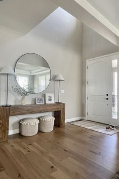 a living room filled with furniture and a large mirror on top of a wooden table