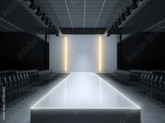 an empty room with rows of chairs and lights on the ceiling, in front of a white wall