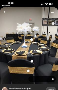 black and gold table cloths are set up for a formal function with white feathers on top