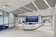 the interior of a medical care unit with blue and white signs on the walls,