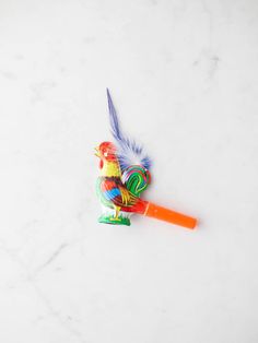 a colorful toy with a feather on top of it