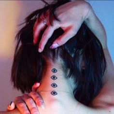 a woman has a tattoo on her neck and shoulder that is decorated with small black dots