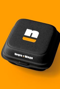 a close up of a black case on an orange background with the words bars and wings