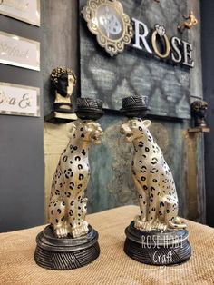 two ceramic cheetah figurines sitting on top of a table