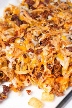 a close up of a plate of food with cheese and other toppings on it