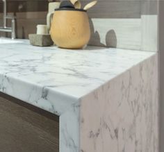 a white marble counter top in a bathroom