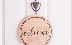 a welcome sign hanging on the front door