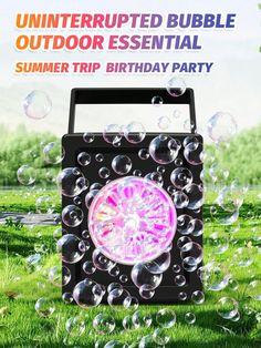 an outdoor birthday party with bubbles floating in the air and a pink light on top