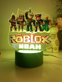 a neon sign that says robbox ndah with some toy figurines on it