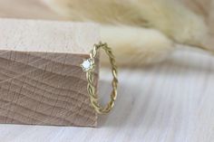 a close up of a ring on a piece of wood with fur in the background