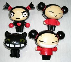 three black and white mickey mouse figurines with red bows on their heads, one in the shape of a cat