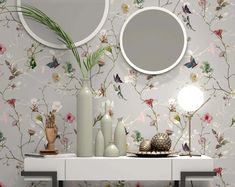 a white table topped with two mirrors and vases